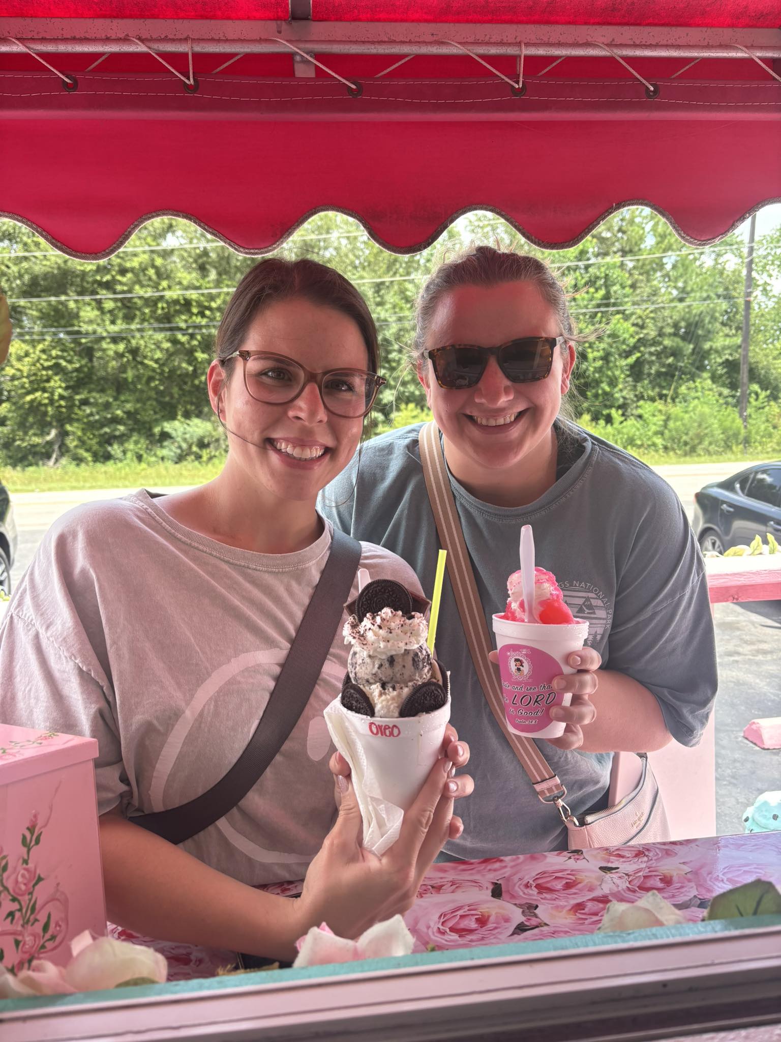 Happy customer enjoying a snowcone at Junie B’s Snowcones stand